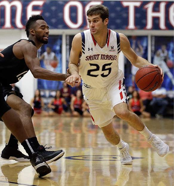 Saint Mary&#039;s Joe Rahon, right, drives the ball against Nevada&#039;s D.J. Fenner during the first half of an NCAA college basketball game Friday, Nov. 11, 2016, in Moraga, Calif. (AP Photo/Ben Margot)