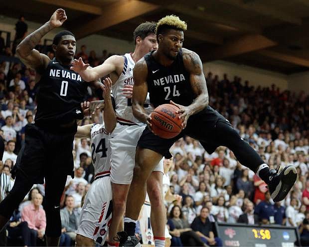 Nevada&#039;s Jordan Caroline, right, pulls in a rebound next to Saint Mary&#039;s Joe Rahon during the first half of an NCAA college basketball game Friday, Nov. 11, 2016, in Moraga, Calif. At left is Nevada&#039;s Cameron Oliver. (AP Photo/Ben Margot)