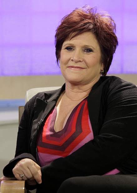 FILE - In this Tuesday, Sept. 29, 2009 file photo, actress and writer Carrie Fisher appears on the NBC &quot;Today&quot; television program in New York to discuss &quot;Wishful Drinking,&quot; her autobiographical solo show on Broadway. On Tuesday, Dec. 27, 2016, a publicist said Fisher has died at the age of 60. (AP Photo/Richard Drew, File)