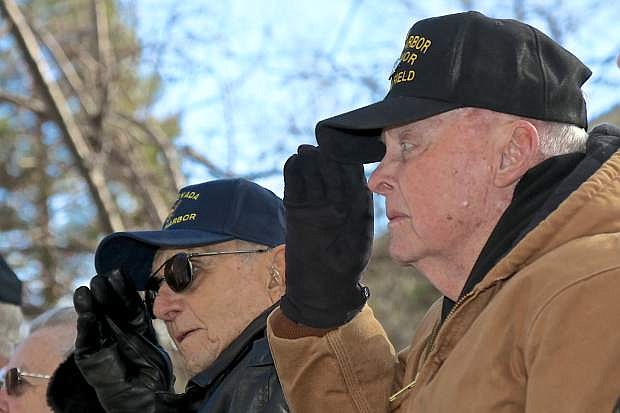 Pearl Harbor survivors Delmar Schwichtenberg (left) and Robert Lloyd stand and salute as Taps is played Wednesday morning at the Capitol.