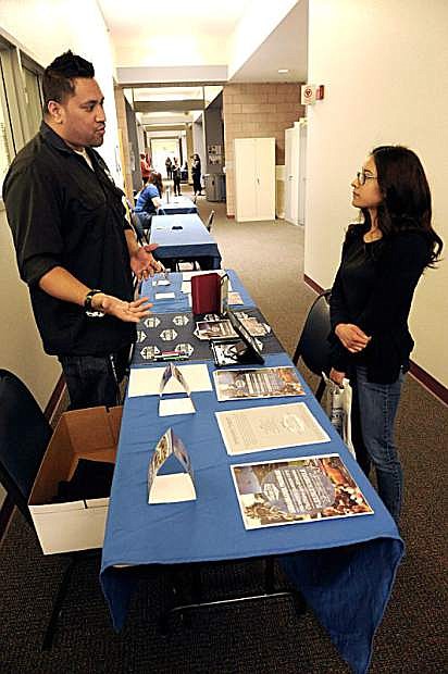 Maricela Segura, 17, right, of Carson City, talks with James Salanoa with the Carson City Visitors Bureau during the Opportunity Career Fair at Western Nevada College on April 1.