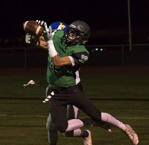 Christian Nemeth goes airborn to catch a pass during a Greenwave game against Lowry earlier this year.