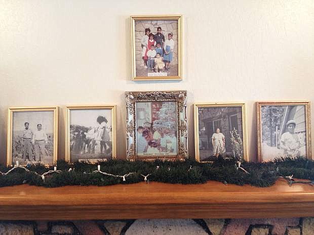 Photos of the Wungnema family are seen on the mantle over the fireplace in the Wungnema House in Mills Park. To see inside the historic site, attend an open house on Sunday, Dec. 18.