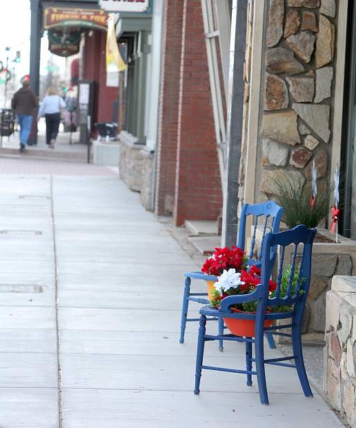 Downtown merchants are decorating the sidewalks with chairs and tables to attract customers.