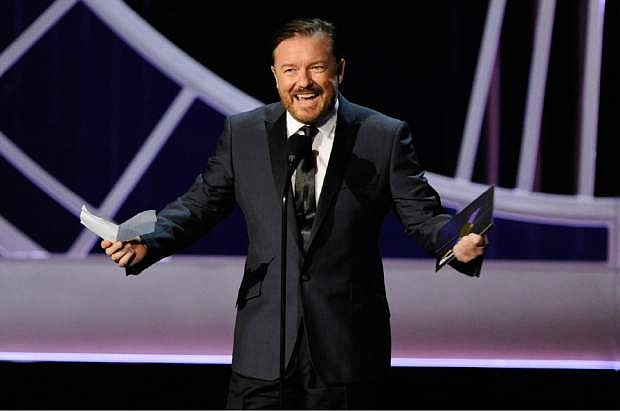 Ricky Gervais presents the award for outstanding writing for a variety, music or comedy special on stage at the 66th Annual Primetime Emmy Awards at the Nokia Theatre L.A. Live on Monday, Aug. 25, 2014, in Los Angeles. (Photo by Chris Pizzello/Invision/AP)