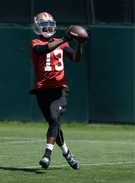 FILE - In this June 17, 2014 file photo, San Francisco 49ers wide receiver Stevie Johnson (13) catches a pass during NFL football minicamp in Santa Clara, Calif. Johnson had produced three straight 1,000-yard seasons with 23 touchdown catches as Buffalo&#039;s most dynamic player in the passing game when that streak ended in frustrating fashion last year. There were injuries and the unexpected death of his mother. Now he has a chance to start a new streak with his new team, back home in the Bay Area. AP Photo/Jeff Chiu, File)
