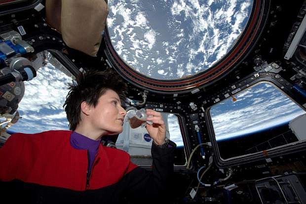 In this photo posted on Twitter, Sunday, May 3, 2015, and provided by NASA, Italian astronaut Samantha Cristoforetti sips espresso from a cup designed for use in zero-gravity, on the International Space Station. Cristoforetti, the first Italian woman in space, fired up the first espresso machine in space, which uses small capsules, or pods, of espresso coffee. (NASA via AP)