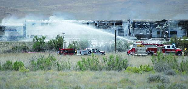 Published Caption: Firefighters from Fallon/Churchill and Naval Air Station Fallon extinguish a fire that engulfed several rail passenger cars on June 24, 2011. The National Transportation Safety Board conducted a hearing on Tuesday and cited three probable causes for the accident and loss of life.