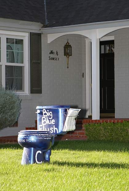 Members of the sophomore class start a fundraiser Wednesday evening by dropping off a bright blue toilet on the lawn of Carson City Mayor Bob Crowell.