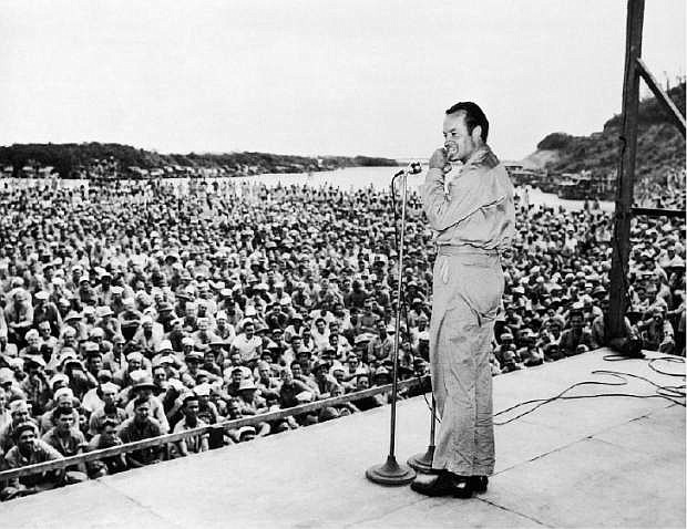 FILE - In this  Oct. 31, 1944 file photo provided by the U.S. Army, Bob Hope performs for servicemen at Munda Airstrip, New Georgia. By the time he died in 2003 at age 100, Hope had conquered vaudeville, Broadway, recordings, live concerts, radio, films and, from its infancy, TV, where he remained a welcome presence into his 90s. (AP Photo/U.S. Army)