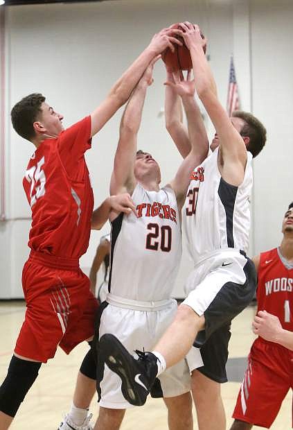 Dalton Davis and Ian Ozolins battle for a rebound in a game against wooster on Tuesday night.