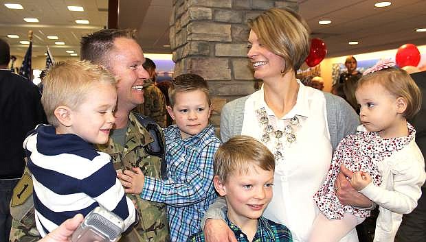 1stLt. Nigel Harrison,  his wife Alyssa and four children reunite Sunday after he returned home from a 10-month deployment to Afghanistan.