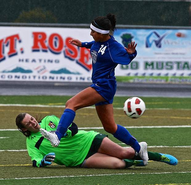 Chantal Torres collides with the Damonte goalie on Saturday at Damonte High School. The Senator girls won 1-0.