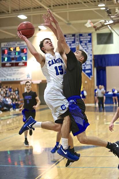 Senior Geraet Rauh drives in to the bucket against McQueen Friday night at Morse Burley Gymnasium. The Senators won the matchup 68-46.
