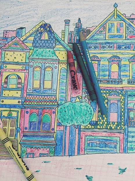 This June 17, 2015 photo shows a colored-in page from the adult coloring book &quot;Splendid Cities: Color Your Way to Calm,&quot; by Rosie Goodwin and Alice Chadwick, Hachette Livre (Editions Marabout). It&#039;s one of dozens of adult coloring books being marketed these days as a way to relieve stress. (Beth J. Harpaz/Little Brown and Company via AP)