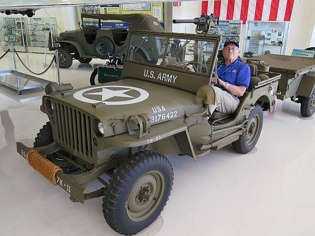 Bill Schultz, 89, a WW II veteran, sits in a 1942 Army Jeep that is displayed in the military vehicle section of the Lyon Air Museum.