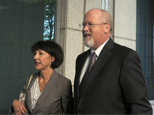 FILE - In this May 14, 2013, file photo, Harvey Whittemore and his wife, Annette, arrive at federal court in Reno for the start of his trial. Whittemore is seeking to overturn his felony conviction and prison sentence for illegal campaign fundraising for U.S. Sen. Harry Reid. Whittemore&#039;s lawyers are asking the 9th U.S. Circuit Court of Appeals to toss out his conviction for funneling nearly $150,000 in illegal contributions to  to Sen. Harry Reid&#039;s campaign in 2007. (AP Photo/The Gazette-Journal, Marilyn Newton, File)