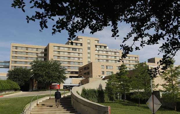 A man walks up the stairway leading to the Texas Health Presbyterian Hospital in Dallas, Tuesday, Sept. 30, 2014.  A patient in the hospital is showing signs of the Ebola virus and is being kept in strict isolation with test results pending, hospital officials said Monday. (AP Photo/LM Otero)