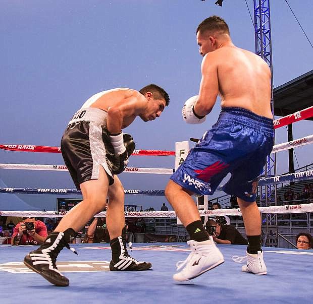 Reno&#039;s Oscar Vasquez, right, watches Jose Toribio drop to the canvass in the seventh round of their flyweight bout during the eighth annual Fallon Fights at the Churchill County Fairgrounds. Vasquez won by knockout.