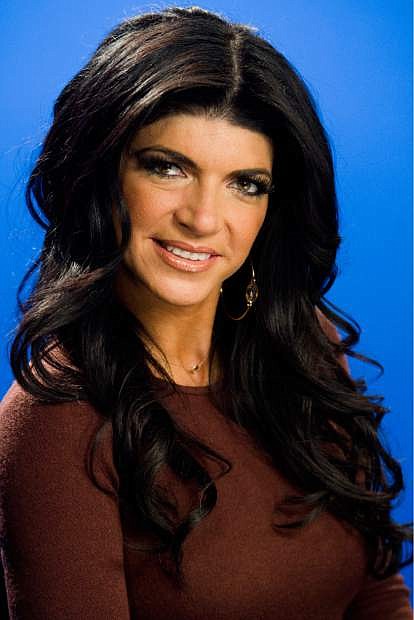 File- This Jan. 4, 2012, photo shows Teresa Giudice posing for a portrait in New York. Giudice is scheduled to report to a federal prison in Danbury, Connecticut on Monday, Jan. 5, 2015, to begin serving a 15-month sentence for bankruptcy fraud. She and husband Joe Giudice pleaded guilty last year. The couple admitted hiding assets from bankruptcy creditors and submitting phony loan applications to get some $5 million in mortgages and construction loans. (AP Photo/Charles Sykes, File)