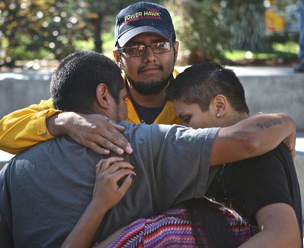 The family of Donovan Garcia, Jr. share a moment in Mills Park Saturday.