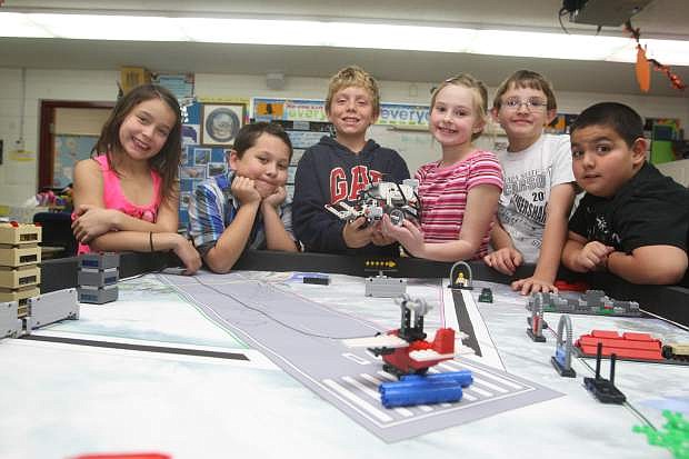 Fritsh Elementary 4th graders, from left, Eviana McGowan, Oscar Salazar, Harper Lopiccolo, Kyra Fields, Nicholas Melsheimer and Oscar Flores display their Lego robot.