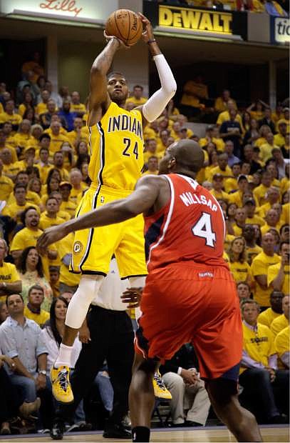 Indiana Pacers forward Paul George (24) shoots over Atlanta Hawks forward Paul Millsap (4) in the second half during Game 7 of a first-round NBA basketball playoff series in Indianapolis, Saturday, May 3, 2014. The Pacers won 92-80. (AP Photo/AJ Mast)