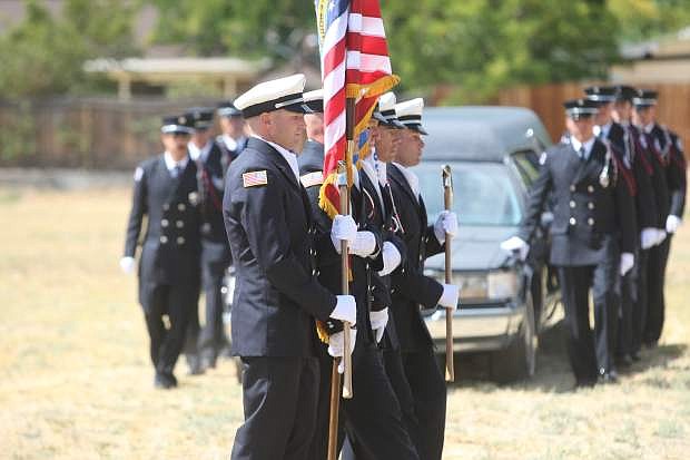 Members of the East Fork Fire &amp; Parmedic Districts carry the flags during the mock funeral service at Carson City&#039;s First Baptist Church on Friday. Local fire departments and law enforcement participated in a week long Honor Guard Academy ending with a funeral service and graduation ceremony for participants.