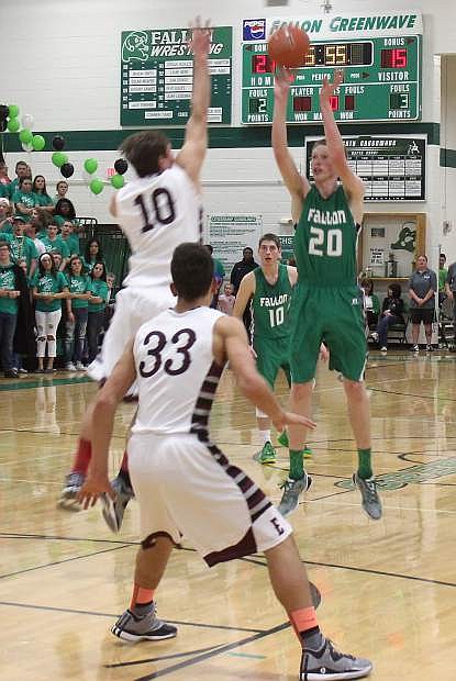 Fallon senior Jeff Evett drains a 3-pointer during the first half of the Greenwvave&#039;s 66-43 loss to Elko in the first round of the Northern Division I-A regional basketball tournament on Friday at the Elmo Dericco Gym.