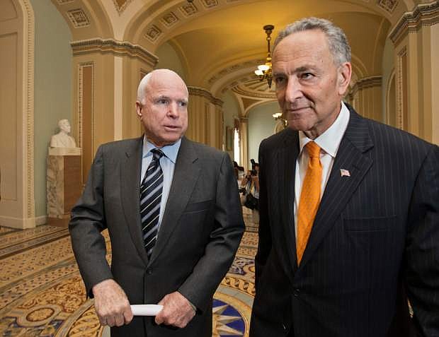 Sen. John McCain, R-Ariz., left, and Sen. Charles Schumer, D-N.Y., right, two of the authors of the immigration reform bill crafted by the Senate&#039;s bipartisan &quot;Gang of Eight,&quot; confer on Capitol Hill in Washington, Thursday, June 27, 2013, prior to the final vote. The historic legislation would dramatically remake the U.S. immigration system and require a tough new focus on border security.  (AP Photo/J. Scott Applewhite)