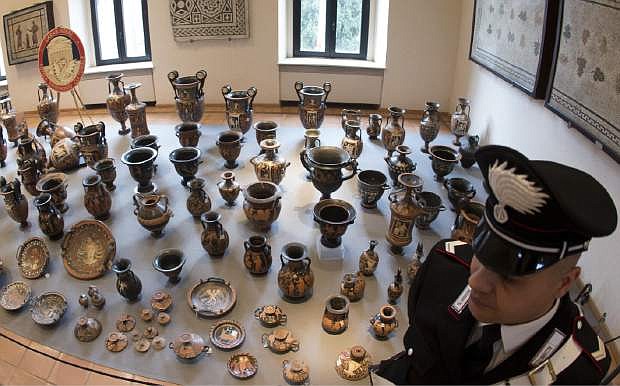 Antiquities recovered by Italian Carabinieri, military police, are displayed at Terme di Diocleziano museum during a press conference in Rome, Wednesday, Jan. 21, 2015. Italian authorities have unveiled what they said was a record haul of rare antiquities illegally looted from Italy and discovered during raids on Swiss warehouses belonging to an accused Sicilian art dealer. The carabinieri police&#039;s art squad estimated the value of the 5,361 vases, kraters, bronze statues and frescoes at some 50 million euros. The works, from the 8th century B.C. to the 3rd century A.D., were laid out Wednesday at the National Roman Museum and may go on public display. Carabineri Gen. Mariano Mossa said it was &quot;by a long shot the biggest recovery in history in terms of the quantity and quality of archaeological treasures.&quot; They were found during an investigation into Basel-based art dealer Gianfranco Becchina, accused by prosecutors of being part of a huge trafficking network. (AP Photo/Claudio Peri, Ansa)