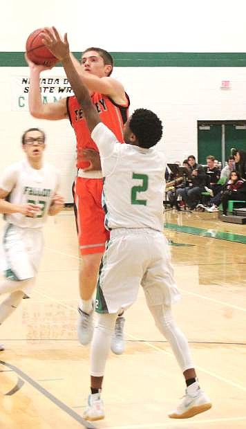 Elijah Jackson leaps to block a basket during a game against Fernley earlier this season.