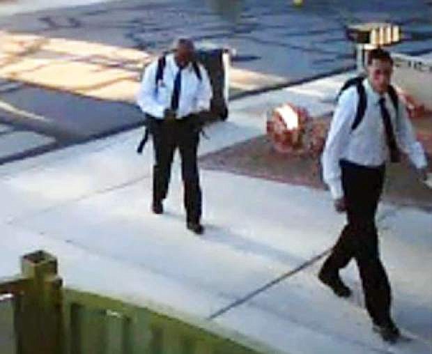 This image provided by the Las Vegas Metropolitan Police Department shows photos from home surveillance video of two suspects who apparently dressed as Mormon missionaries and asked a man to talk about religion before robbing him at gunpoint on the evening of June 27 in the southwest part of the Las Vegas valley. Police say the victim spoke with the men for about five minutes before they jumped him, punched him and stole property at gunpoint. (AP Photo/Las Vegas Metropolitan Police Department)