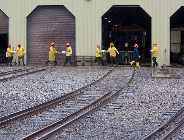A NDF crew work to sandbag the annex building at the Nevada State Railroad Museum on Tuesday.