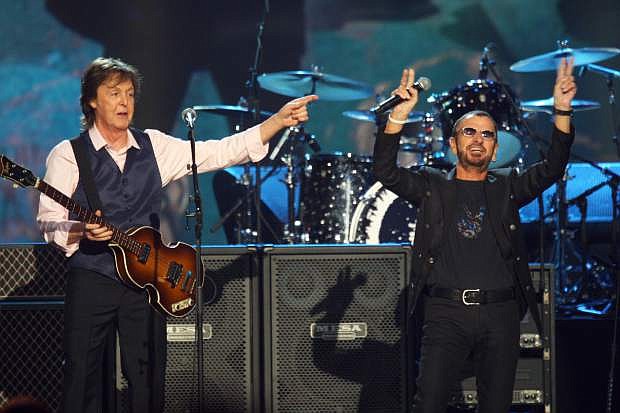 FILE - In this Jan. 27, 2014 file photo, Paul McCartney, left, and Ringo Starr perform at The Night that Changed America: A Grammy Salute to the Beatles in Los Angeles. McCartney will induct his former Beatle mate, Ringo Starr, into the Rock and Roll Hall of Fame next month. The 30th annual induction ceremony is scheduled for Cleveland&#039;s Public Hall on April 18. (Photo by Zach Cordner/Invision/AP, File)
