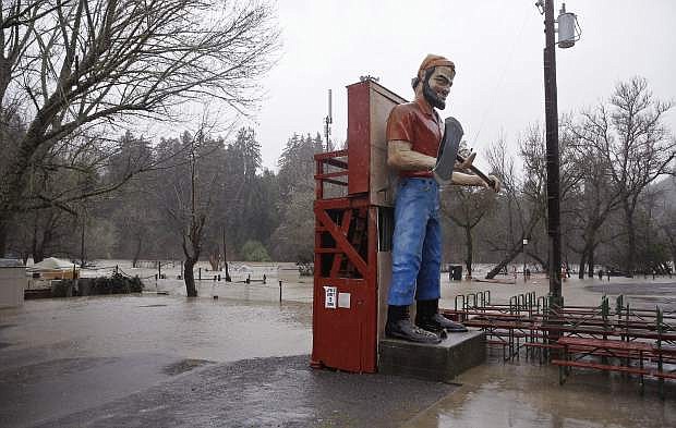 The Russian River floods the River Bend RV park Tuesday, Jan. 10, 2017, in Forestville, Calif. The latest in an onslaught of winter storms comes with blizzard warnings for the Sierra Nevada and a new round of flooding for Northern California river towns where thousands of people remained under evacuation advisory Tuesday. (AP Photo/Eric Risberg)