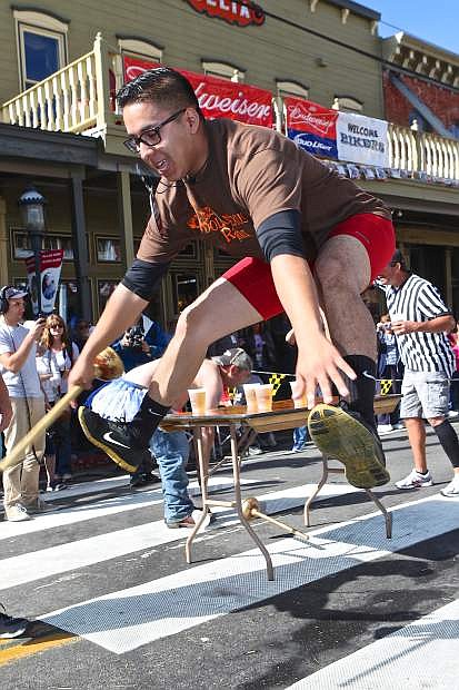 A competitor for Rosewood Lakes Apartment&#039;s underwear relay team performs calisthenics after drinking a beer Saturday in Virginia City.