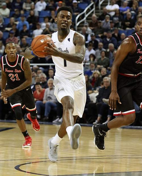 Marcus Marshall pushes the basketball for Nevada against Fresno State on Saturday at Lawlor Events Center.