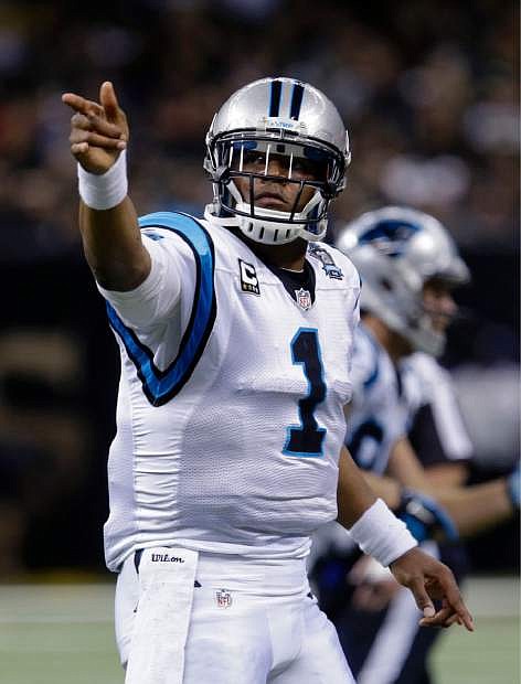 Carolina Panthers quarterback Cam Newton (1) gestures after a first down in the first half of an NFL football game against the New Orleans Saints in New Orleans, Sunday, Dec. 7, 2014. (AP Photo/Bill Feig)