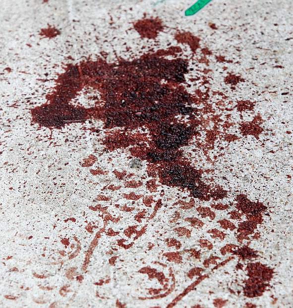 Bloody footprints seen outside the house in the 7318 Enchanted Creek, Sunday, Nov. 10, 2013, after two people were killed and at least 22 others were injured Saturday night when gunfire rang out at a large house party in a Houston suburb, sending partygoers fleeing in panic, authorities said. Authorities say they&#039;re seeking two gunmen. (AP Photo/Bob Levey)
