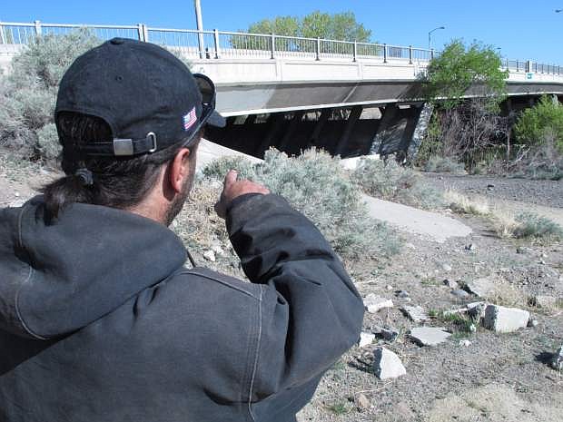 Robert Wynters points to the spot where he says sheriff&#039;s deputies seized the belongings he and other homeless people had stashed for safe keeping beneath a bridge over the Truckee River on the east edge of Reno, Nev., on April 17, 2015.   Wynters, 42, has filed a lawsuit in U.S. District Court accusing Washoe County of confiscating and destroying his property without prior notice or due process in violation of his constitutional rights. (AP Photo/Scott Sonner)