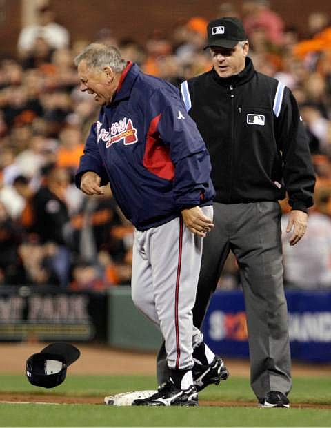 FILE - In this Oct. 8, 2010 file photo, Atlanta Braves manager Bobby Cox throws his hat in front of umpire Paul Emmel just before he was ejected for arguing that Alex Gonzalez was safe in the second inning of Game 2 of the  National League Division Series baseball game against the San Francisco Giants in San Francisco. With baseball&#039;s expanded replay rule this season, those colorful, saliva-trading tirades Bobby Cox and Lou Piniella made famous could very well be replaced by far more civilized behavior. (AP Photo/Ben Margot, File)