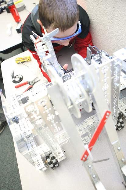 Twelve-year-old Matthew Nugent of The Enterprisers replaces the computer for his teams robot during the competition on Saturday at Western Nevada College.