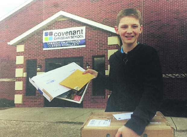 Victor Schultz, a seventh grade student at Covenant Christian School in Mishawaka, Ind., holds items Carson City residents mailed to him. Victor reached out to Nevada Appeal readers in January for help with a school project about Nevada.