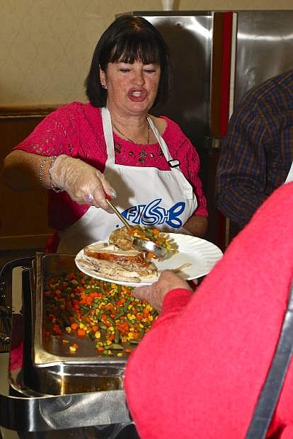 Carson City Board of Supervisor member Lori Bagwell serves vegetables at the Carson Nugget Thursday.
