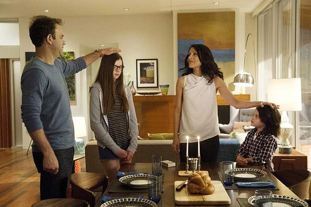 This image released by Bravo shows Paul Adelstein, from left, Conner Dwelly, Lisa Edelstein, and Dylan Schombing in a scene from &quot;Girlfriends&#039; Guide to Divorce,&quot; Bravo&#039;s first original scripted series, premiering Dec. 2. (AP Photo/Bravo, Carole Segal)