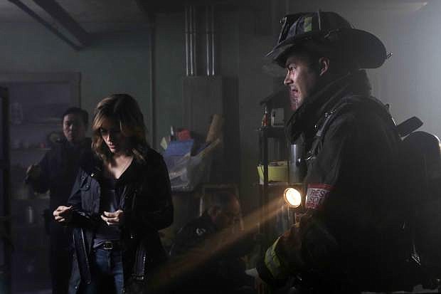 This photo provided by NBC shows Sophia Bush as Erin Lindsay, left, and Taylor Kinney as Kelly Severide, in the episode &quot;Nobody Touches Anything&quot;  of season 3 on NBC&#039;s &quot;Chicago Fire.&quot; A story arc about a child pornography ring will be featured on three NBC shows Tuesday and Wednesday, Nov. 11-12, 2014, including &quot;Chicago Fire,&quot; &quot;Chicago P.D.&quot; and &quot;Law and Order: SVU.&quot;  (AP Photo/NBC, Elizabeth Morris)