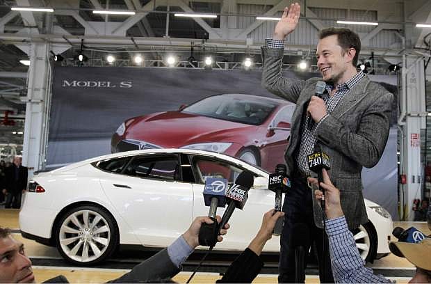 FILE - In this June 22, 2012 file photo, Tesla CEO Elon Musk waves during a rally at the Tesla factory in Fremont, Calif. Tesla Motors has selected Nevada for a massive, $5 billion factory that it will build to pump out batteries for a new generation of electric cars, a person familiar with the company&#039;s plans said Wednesday, Sept. 3, 2014. (AP Photo/Paul Sakuma, File)