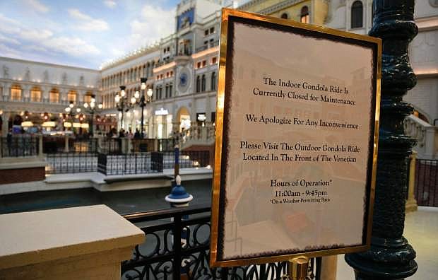A sign posted at St. Mark&#039;s Square at the Venetian hotel-casino notifies visitors of the reason for the drained canals, Thursday, Sept. 19, 2013, in Las Vegas.  Management has closed the waterways for several weeks for maintenance. (AP Photo/Julie Jacobson)