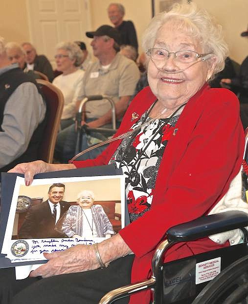 Phyllis Bendure beams as she sits with her photo with Gov. Sandoval at the State of the State last week.